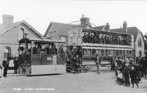 Covered steam tram and trailer.